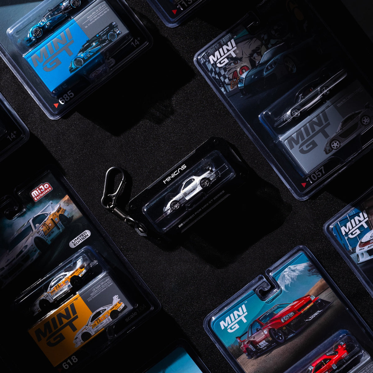 GT-TAG 64 close-up holding MINI GT blister pack